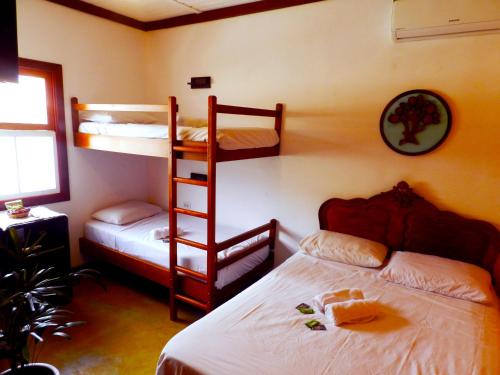 a bedroom with two bunk beds and a ladder at Atlantic Hospedagem in São Sebastião