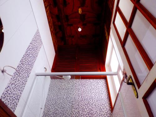 a staircase in a building with a red door at Atlantic Hospedagem in São Sebastião