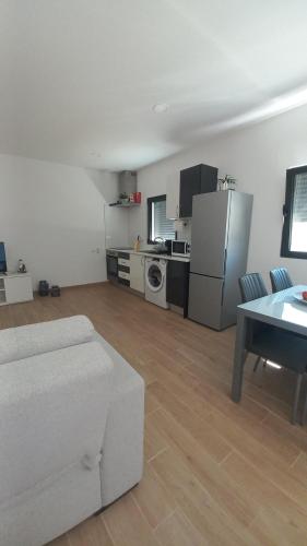 a living room with a white couch and a refrigerator at Quinta das Reveladas in Marvão
