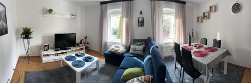 a living room with a couch and a table at Apartament nad rzeką in Kowary