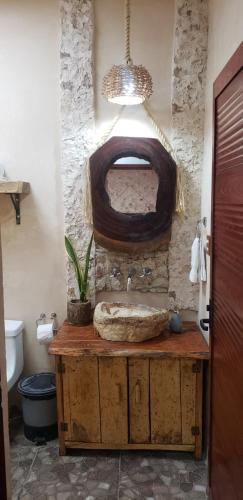 a bathroom with a wooden sink and a potted plant at Casa los Jarochos in Valladolid