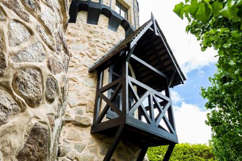 a black lantern on the side of a stone building at Castle Keep B&B in the Tower. in Crafers