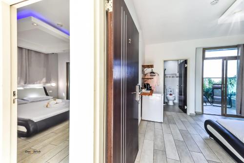a bedroom with a bed and a room with a door at the royal lake views in Tiberias