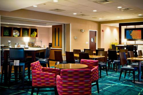 a restaurant with tables and chairs and a bar at SpringHill Suites Sarasota Bradenton in Sarasota