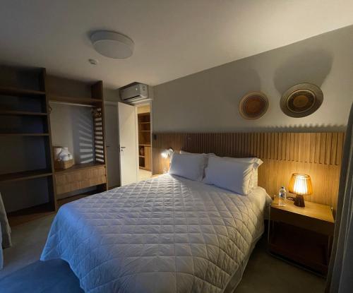 a bedroom with a large bed with a white bedspread at Guarajuba Suítes Premium Boutique Hotel in Guarajuba