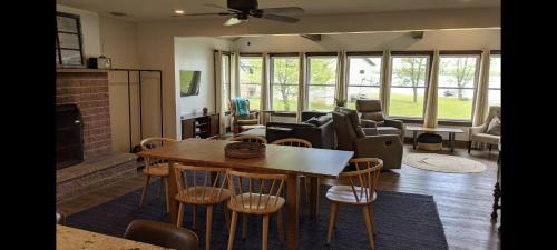 a living room with a table and chairs at Whitney Bay House on CHQ Lake in Mayville