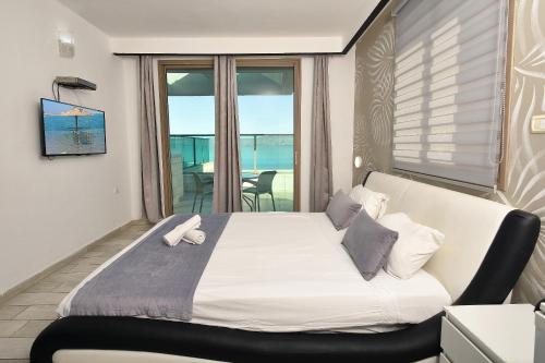 a bedroom with a bed with a view of the ocean at the royal lake views in Tiberias