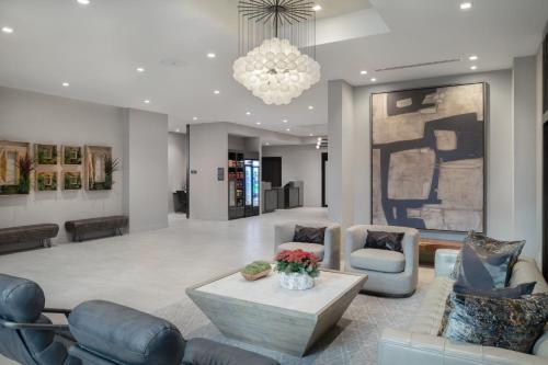 a lobby with couches and a table and a chandelier at TownePlace Suites by Marriott Framingham in Framingham