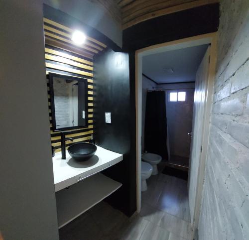 a bathroom with a sink and a toilet at Alojamiento el Ancla in San Rafael