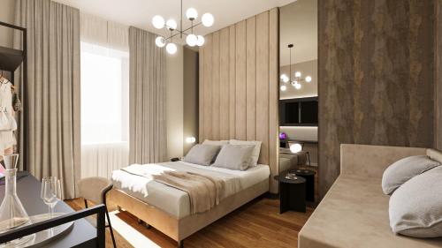 a bedroom with a bed and a couch at Home at Rome Luxury Navona in Rome