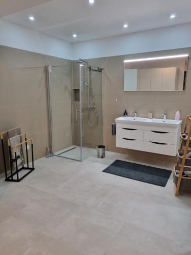 a bathroom with a sink and a shower at Villa Melanie in Umag
