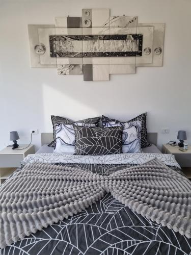 a bed with a comforter on it in a bedroom at Villa Melanie in Umag