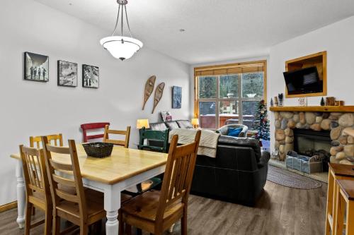 a living room with a table and a couch at Crystal Forest #48 By Bear Country in Sun Peaks