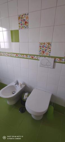a bathroom with a toilet and a sink at AL "Villa Por Do Sol" Sunset Olhão in Olhão