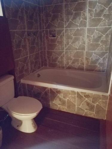 a bathroom with a toilet and a bath tub and a toilet at Grand Titanic, Boat House in Punta Allen