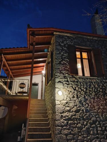 a stairway leading up to a building at night at 1935 home in Lílaia