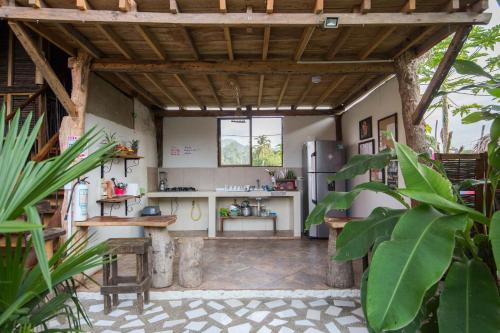 a kitchen with a refrigerator and a table at Bella Flor Hostel Palomino in Palomino