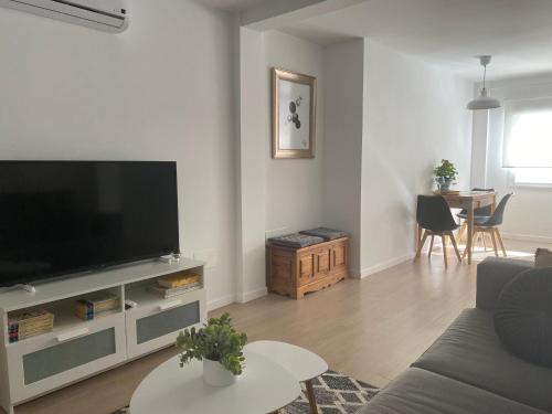 a living room with a large flat screen tv at Casa La Victoria in Málaga