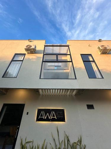 a building with a sign on the side of it at Awa House Hotel in Aguachica