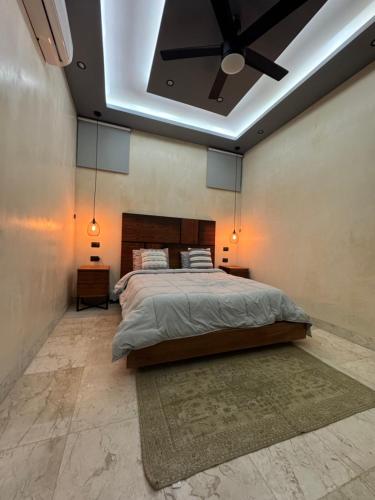 a bedroom with a bed and a ceiling fan at Kasa Nikte in Tulum