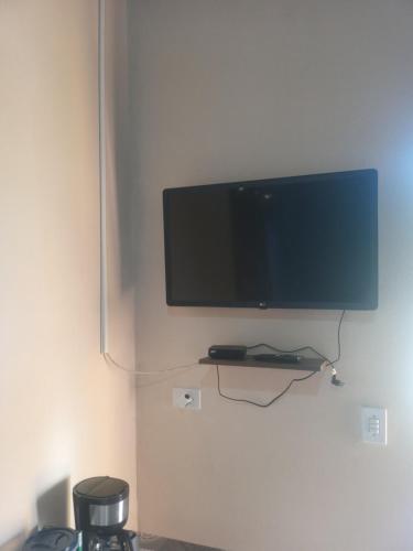 a flat screen tv hanging on a wall at Refúgio Encantado in Eldorado