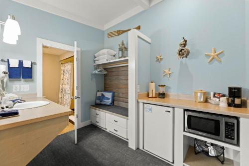 a bathroom with a sink and a counter with a microwave at Harborview Inn & RV Park in Garibaldi