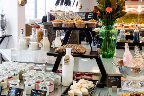 a display in a bakery with cupcakes and other desserts at Augustine, a Luxury Collection Hotel, Prague in Prague