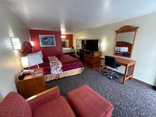 a hotel room with a bed and a desk at Knights Inn Punta Gorda in Punta Gorda