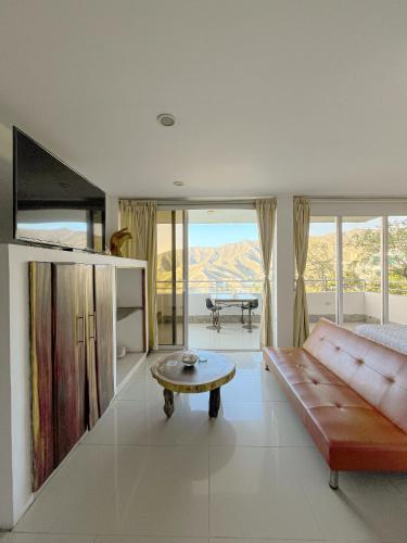 a living room with a couch and a table at Hotel TNT Mirador in Taganga