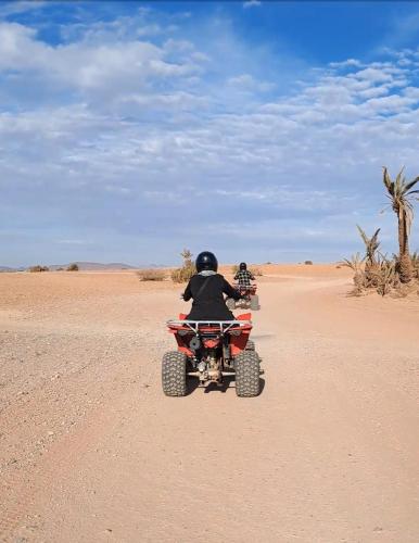 Dos personas montadas en un vehículo de cuatro ruedas en el desierto en Gondotour Quad tour, en São Pedro da Cova