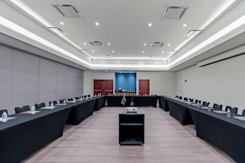 an empty room with rows of chairs and a podium at City Express by Marriott Hermosillo in Hermosillo