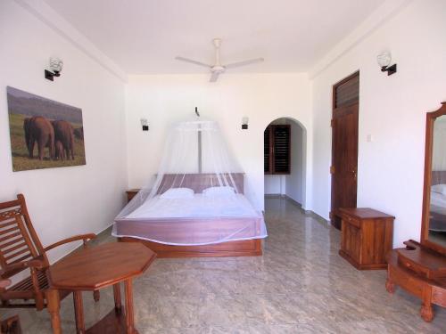 a bedroom with a bed with a mosquito net at Villa Riverplace in Beruwala
