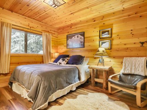 加文門特營的住宿－Govy Alpine Getaway，小屋内一间卧室配有一张床和一把椅子