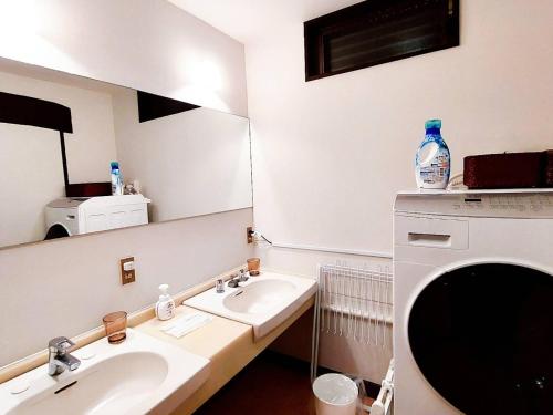 a bathroom with two sinks and a large mirror at DAVID NO YAKATA - Vacation STAY 16849v in Yufuin