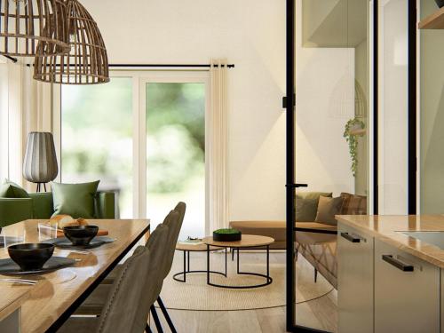 a kitchen and dining room with a table and chairs at Chalet in Veluwe with Peaceful Surroundings in Voorthuizen