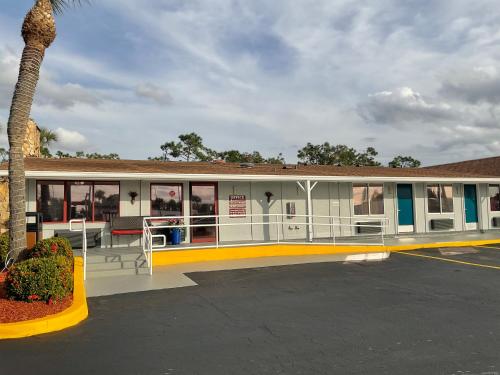 a gas station with a palm tree in a parking lot at Knights Inn Punta Gorda in Punta Gorda