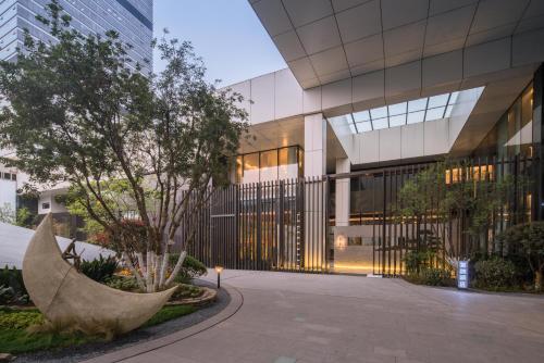 an external view of a building at Wuyu Sky Garden Hotel Chongqing Zoo & Yangjiaping The Mixc Light rail in Chongqing