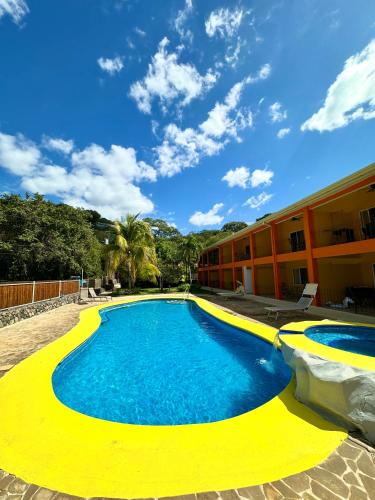 a large swimming pool in front of a building at Discounted - Hermosa Paradise Mins From Beach in Playa Hermosa