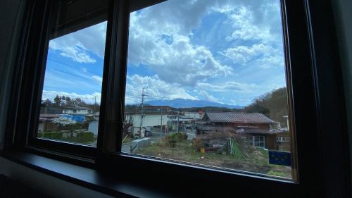 a window with a view of a city at Holiday home Furinkazan 風林火山 in Fujikawaguchiko