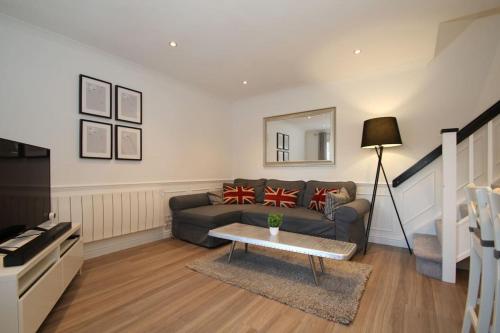 a living room with a couch and a table at Lovely house overlooking field with woodland walks in Blackwater