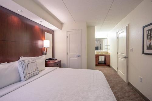 a hotel room with a bed and a bathroom at Residence Inn by Marriott Amelia Island in Fernandina Beach