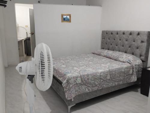 a bedroom with a bed and a fan at Casa Descanso La Campiña 101 in Cali