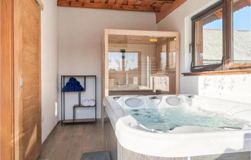 a bathroom with a large tub with a window at Stunning Home In Brusane With Outdoor Swimming Pool, Wifi And 3 Bedrooms in Brušane