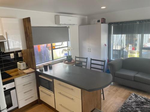 a kitchen with a table and a couch in a room at Ohope Dreamer 2 in Ohope Beach
