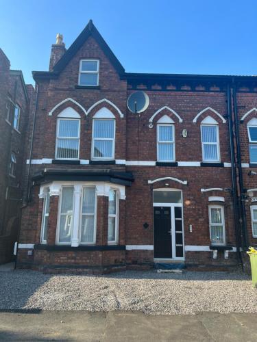 a red brick building with a door and windows at Brand NEW apartment with FREE Parking, Sleeps 4, near Beach & City Centre in Waterloo