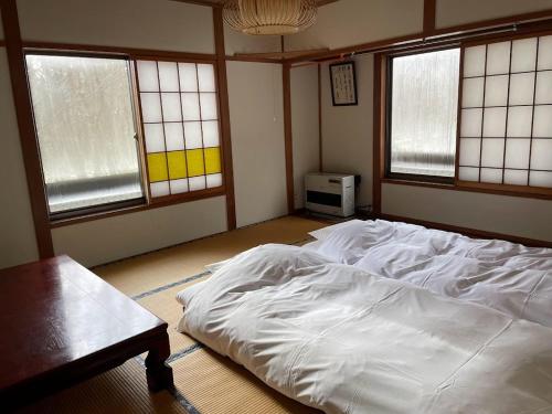 Cama ou camas em um quarto em Maison de Sasagawa