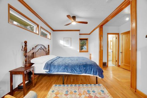 a bedroom with a bed and a ceiling fan at Beautiful Historic House in Central Longmont in Longmont