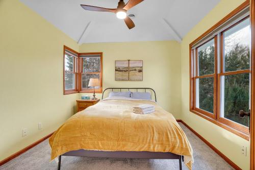 a bedroom with a bed and a ceiling fan at Beautiful Historic House in Central Longmont in Longmont