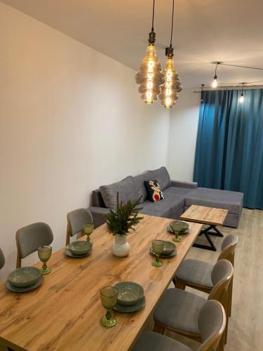 a dining room with a wooden table and a couch at SevenHills chalet in Yablunytsya
