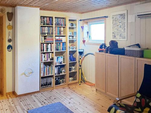 a room with book shelves filled with books at Holiday home Vikholmen 